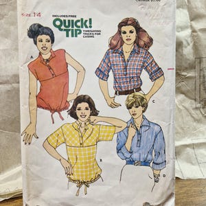 May include: Butterick sewing pattern 5934, size 14, featuring illustrations of four different shirt styles labeled A, B, C, and D. The envelope includes text for Quick! Tip timesaving tricks for casing and displays the Butterick brand name.