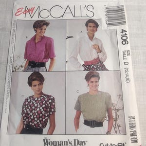 May include: McCall's sewing pattern envelope featuring four blouse designs. The envelope includes images of the finished blouses, with options for short sleeves, long sleeves, and various patterns. The Woman's Day Collection is featured on the front.