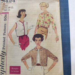 May include: Vintage sewing pattern for a cropped jacket with three different styles. The pattern is for size 12 and bust 34. The pattern is printed on paper and has a blue border.