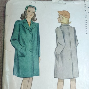 May include: A vintage sewing pattern featuring two women wearing coats. The woman on the left is wearing a green coat with a button closure and a headband. The woman on the right is wearing a gray coat with a button closure and a cap. The text "PRINTED PATTERN" is visible in the upper right corner of the image.