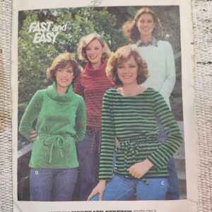 May include: A vintage fashion advertisement featuring four women modeling different knit tops. The tops include a green turtleneck, a red striped turtleneck, a green and black striped top, and a light green sweater. The text "FAST and EASY" is at the top.