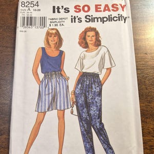 May include: Simplicity pattern 8254, featuring illustrations of two outfits: a blue tank top and striped shorts, and a white top with floral print pants. The package includes the text "It's SO EASY" and "it's Simplicity". Size A, 10-20.