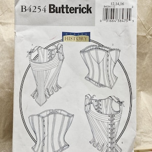 May include: A white Butterick B4254 sewing pattern envelope featuring line drawings of four different corset designs. The text includes "B4254 Butterick", "MAKING HISTORY", and size information 12, 14, 16 with a barcode at the top right corner.