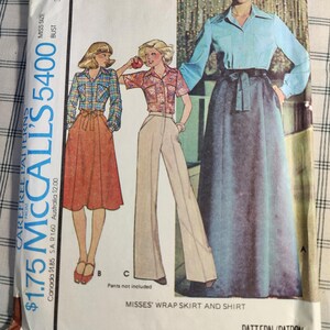 May include: A vintage sewing pattern for a wrap skirt and shirt. The pattern is for misses' sizes 10-32 1/2 and includes instructions for making a wrap skirt and a shirt with a collar and long sleeves. The pattern is from McCall's and is number 5400.