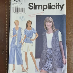 May include: A Simplicity sewing pattern envelope featuring illustrations of women's clothing designs. The envelope includes the pattern number 2579, size B3 L, XL, and measurements in EUR and FR sizes. The price is $9.95.