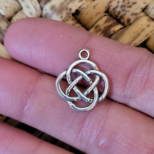 May include: Silver Celtic knot charm pendant. The knot is a traditional symbol of love, friendship, and eternity.