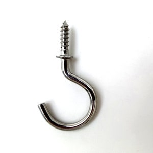 May include: A silver metal hook with a screw thread. The hook is designed for hanging items.