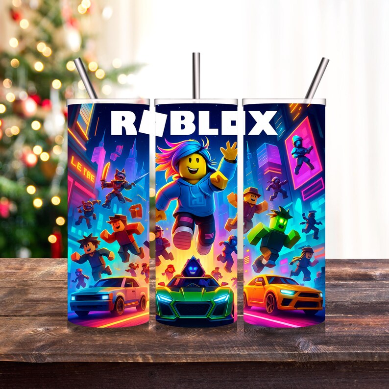 K&ouml;nnte beinhalten: Drei Edelstahlbecher mit dem Wort "ROBLOX" in Wei&szlig;. Jeder Becher hat ein lebendiges Design mit Roblox-Charakteren, Autos und einer Stadtlandschaft. Die Becher haben silberne Strohhalme und stehen auf einer Holzoberfl&auml;che.
