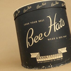 May include: Black hat box with gold lettering that reads "Bee Hats" and "Look Your Best". The box also has a gold label that reads "Wear a Bee Hat" and "Bee Hat Company Inc., St. Louis, Mo."