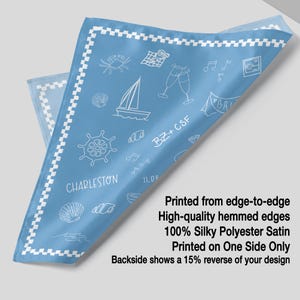 The image is a printed fabric with a design featuring various objects such as a ship, a boat, a lighthouse, and a crab. The text indicates that the fabric is printed from edge-to-edge, has high-quality hemmed edges, and is made of silk polyester satin. The fabric is printed on one side only, and the backside shows a 15% reverse of the design.