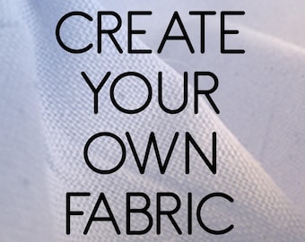 May include: A light blue fabric with the text "CREATE YOUR OWN FABRIC" in black. The fabric appears to be soft and textured, with folds and shadows creating depth. The background has a gradient effect.
