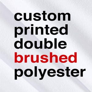 May include: White fabric with the words "custom printed double brushed polyester" in black and red text. The text is vertically stacked, with "brushed" in red.