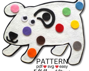 May include: White felt dog with black eyes and a black swirl on its back. The dog has colorful felt circles on its body, including pink, purple, green, red, orange, yellow, brown, and gray.