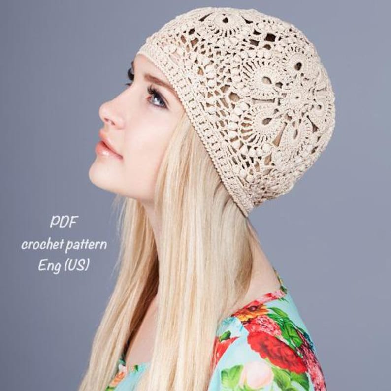 May include: A cream-colored, crocheted hat with a floral design. The hat is made of a soft, open-weave material. The text "PDF crochet pattern Eng (US)" is visible in the image.