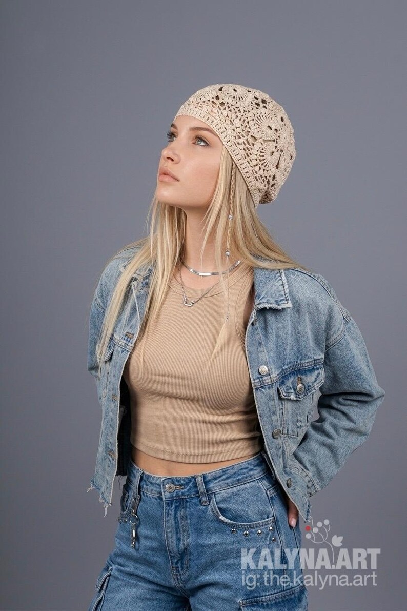 May include: A beige crocheted hat with a floral design. The hat is worn with a denim jacket and jeans. The image also includes the text "KALYNA.ART ig: the.kalyna.art".