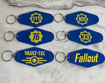 Llaveros estilo motel con número de refugio del videojuego Wastelander de Vault Dweller