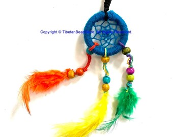 May include: A blue dreamcatcher keyring with a silver ring. The dreamcatcher features a web design and is decorated with orange, yellow, and green feathers, plus wooden beads. A decorative accessory.