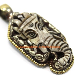 Unique Ethnic Carved Bone Ganesha Pendant with Repousse Carved Silver Plated Brass Floral Edging & Lotus Details on Reverse Side - WM7405