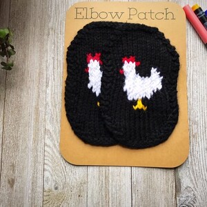 May include: Two black knitted elbow patches with white embroidered chickens. The patches are on a brown card with the text "Elbow Patch" printed in white.