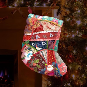 May include: A red, green, and blue patchwork Christmas stocking with a snowman, a crescent moon, and a Santa Claus design.