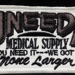 May include: White embroidered patch with the text "Uneeda Medical Supply You Need It---We Got It None Larger" and a red cross and a small image of the United States.