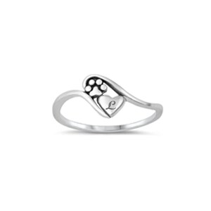 May include: Silver ring with a heart design featuring a paw print and the letter L.