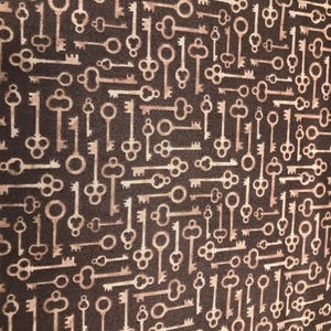 May include: A brown fabric with a repeating pattern of gold keys. The keys are in various sizes and shapes, and they are all facing the same direction.