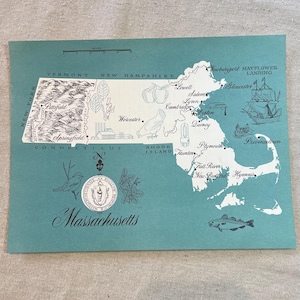 May include: A teal-colored map of Massachusetts with illustrations of landmarks and cities. The map includes the text "Massachusetts" in cursive at the bottom and various city names like Boston and Plymouth.