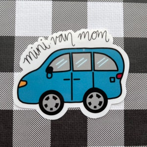May include: A blue minivan sticker with the text "mini van mom" in black cursive writing.