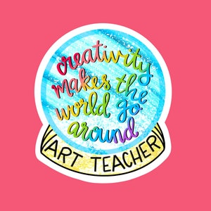 May include: A sticker with a rainbow-colored globe and the text "creativity makes the world go around" and "ART TEACHER" in a yellow banner.