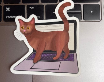 May include: A brown cat with green eyes is walking across a laptop keyboard. The laptop is open and has a white screen with a web page visible. The cat is looking at the screen.