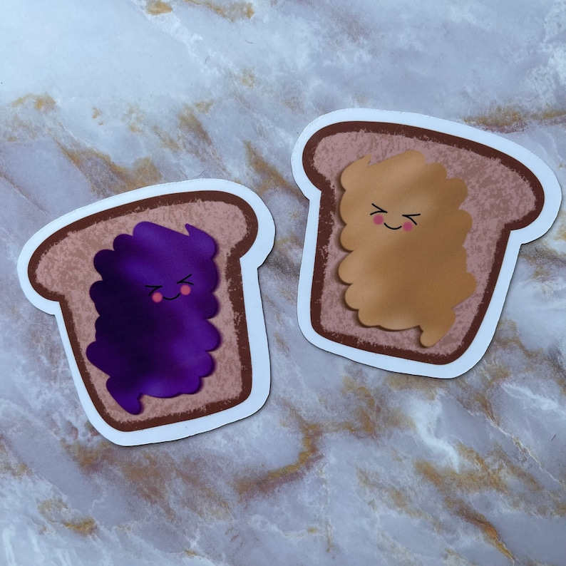 May include: Two cartoon bread slices with happy faces. One slice has purple jelly and the other has brown peanut butter.
