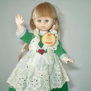 1978 VOGUE GINNY DOLL in original green dress- Hi! I&#39;m Ginny button- blond hair, pinafore, original socks- sleep eyes- 8&quot; doll, cute face