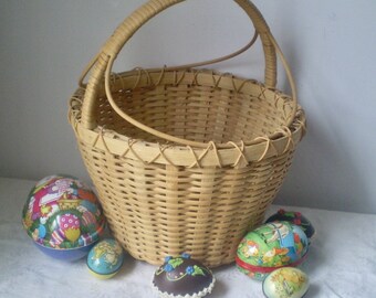 May include: A woven wicker basket with a handle, filled with colorful Easter eggs. The eggs are decorated with cartoon characters and designs.