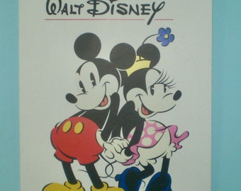May include: A book cover featuring Mickey Mouse and Minnie Mouse. The title reads "The Art of Walt Disney" in red and black text. Mickey wears red shorts and yellow shoes, while Minnie wears a pink dress with white polka dots.