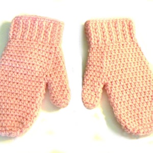 May include: A pair of pink crocheted mittens. The mittens have a simple stitch pattern and are made with a soft yarn.