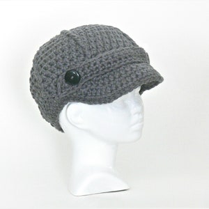 May include: Gray crocheted beanie with a button on the side and a brim.