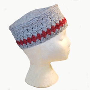 May include: A grey crocheted hat with a red crocheted band around the brim.