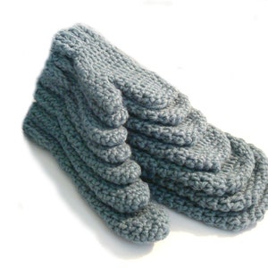 May include: A pair of gray knitted slipper socks with a textured design.