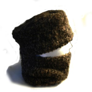 May include: A brown knit hat with a fold-over brim. The hat is made of a soft, fuzzy material.