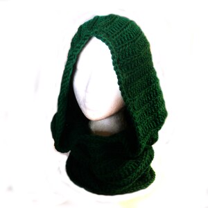 May include: A dark green crocheted cowl with a hood. The cowl is made of a soft, warm yarn and is perfect for keeping you warm in the winter.