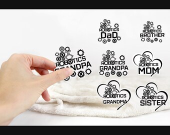 May include: Black and white iron-on transfers with the words "Robotics" and various family member titles, such as "Dad", "Mom", "Grandpa", "Grandma", "Brother", and "Sister".