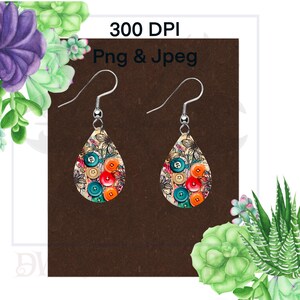 May include: A pair of teardrop-shaped earrings with a floral and button design. The earrings are cream-colored with a variety of colorful buttons, including red, orange, blue, and green. The earrings are hanging from silver hooks.