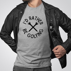 May include: A gray t-shirt with a black graphic that says "I'd Rather Be Golfing" with a pair of crossed golf tees.