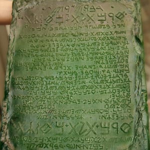 May include: A green stone tablet with an inscription of ancient writing. The inscription includes the text "56ZN-N066x 320x XXX Z NAPSS NA33-74 COYZA SEBIN FOWYXTEXXYX-FREE-76-5546 35-59-3210-2433-24474 &Epsilon;&Omicron;&Upsilon;&Zeta;&Iota;&Epsilon;&Upsilon;&Nu;N: NEEXTENGTEN5525524252 25&times;353-21-2556-50NE 6 752-97264-65DESMOS FETS БОНХЯ XMEOSUNAXTONY-XX&Chi;&Alpha;&Omega;&Nu; DEBI".