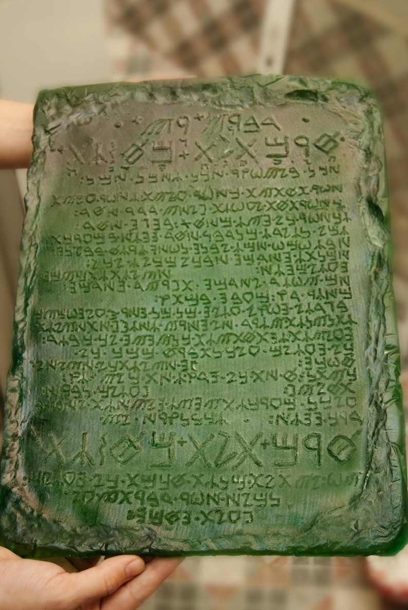 May include: A green stone tablet with an inscription of ancient writing. The inscription includes the text "56ZN-N066x 320x XXX Z NAPSS NA33-74 COYZA SEBIN FOWYXTEXXYX-FREE-76-5546 35-59-3210-2433-24474 &Epsilon;&Omicron;&Upsilon;&Zeta;&Iota;&Epsilon;&Upsilon;&Nu;N: NEEXTENGTEN5525524252 25&times;353-21-2556-50NE 6 752-97264-65DESMOS FETS БОНХЯ XMEOSUNAXTONY-XX&Chi;&Alpha;&Omega;&Nu; DEBI".