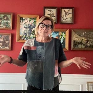 May include: A short-sleeved top constructed from various denim and fabric patches in shades of blue, gray, and white. The garment features a mix of solid panels, striped sections, and textured squares, with a raw, uneven hemline at the bottom edge.