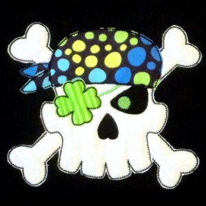 May include: White skull and crossbones with a green shamrock and a black, blue, and yellow polka dot eye patch. The skull has a black eye patch with a green eye.