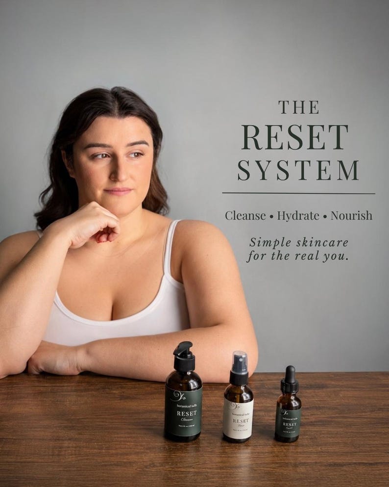 May include: Three amber glass skincare bottles labeled The Reset System, including a pump bottle, a spray bottle, and a dropper bottle. Text on the right reads: THE RESET SYSTEM, Cleanse &bull; Hydrate &bull; Nourish, Simple skincare for the real you.