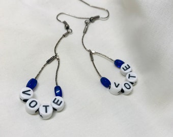 Your vote matters-Election time coming. Place in your ballot in style! Letter beads with blue glass beads wagging tail designs